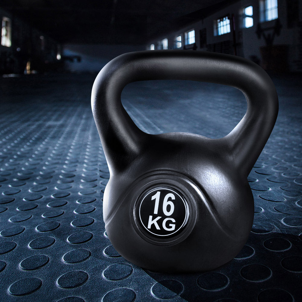 Black Everfit 16kg kettlebell set with dumbbells on a gym lifting bench, ideal for home fitness and weight training.
