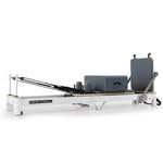 Aluminium Pilates Reformer machine with stretch bed, box, and jump board accessories for yoga and fitness exercises.