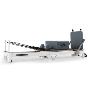Aluminium Pilates Reformer machine with stretch bed, box, and jump board accessories for yoga and fitness exercises.