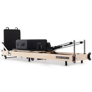 Wooden Pilates Reformer machine with stretch bed, box, and jump board accessories for yoga and Pilates exercises.