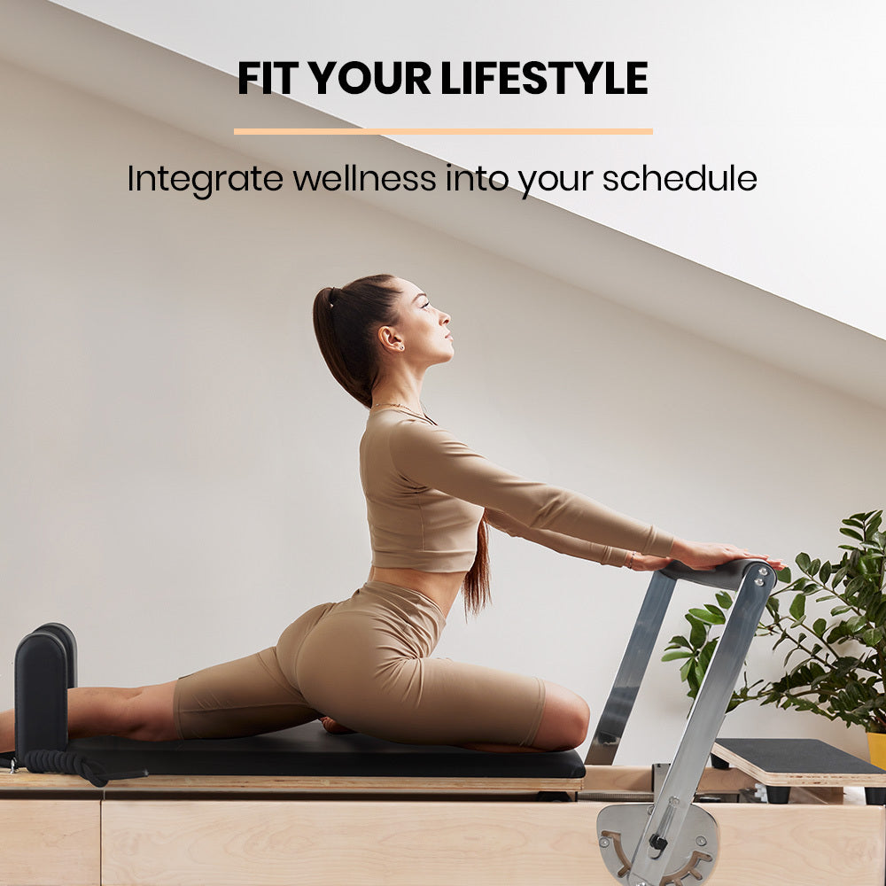 Wooden Pilates Reformer by Online Fitness Depot with stretch bed, box, and jump board accessories for yoga and Pilates exercises.