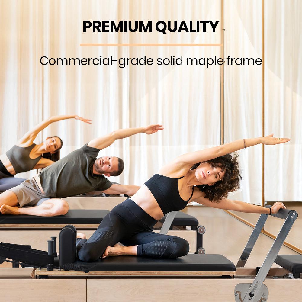 Wooden Pilates Reformer machine with stretch bed, box, and jump board accessories for yoga and fitness exercises.
