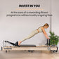 Wooden Pilates Reformer machine with stretch bed, box, and jump board accessories for yoga and fitness exercises.