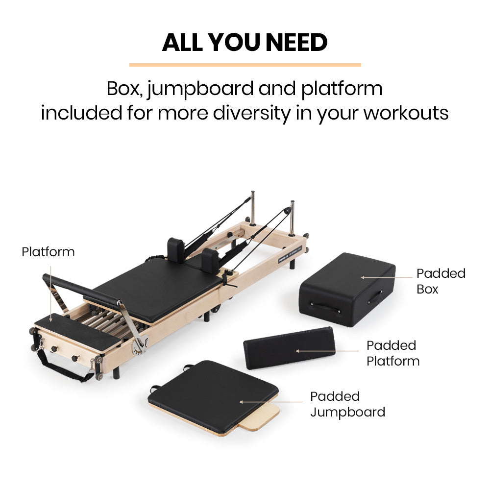 Wooden Pilates Reformer machine with stretch bed, box, and jump board accessories for yoga and fitness exercises.
