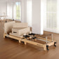 Selina Pilates Reformer Machine in oak beige with wooden frame, jumpboard, and sitting box for home gym exercise by Online Fitness Depot