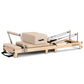 Powertrain Selina Pilates Reformer Machine with wooden frame, jumpboard, and sitting box in oak beige for home Pilates workouts.