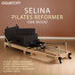 Powertrain Selina Pilates Reformer Machine in black with wooden frame, jumpboard, and sitting box for home gym fitness exercises