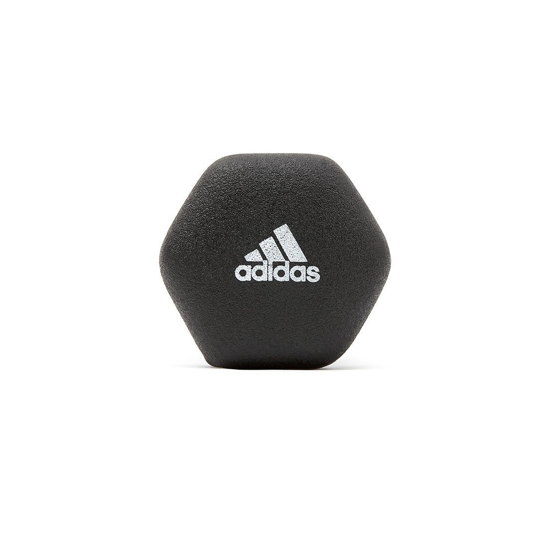 Pair of Adidas Hex Dumbbells for gym training and weight lifting, with black and silver finish, on a fitness floor.