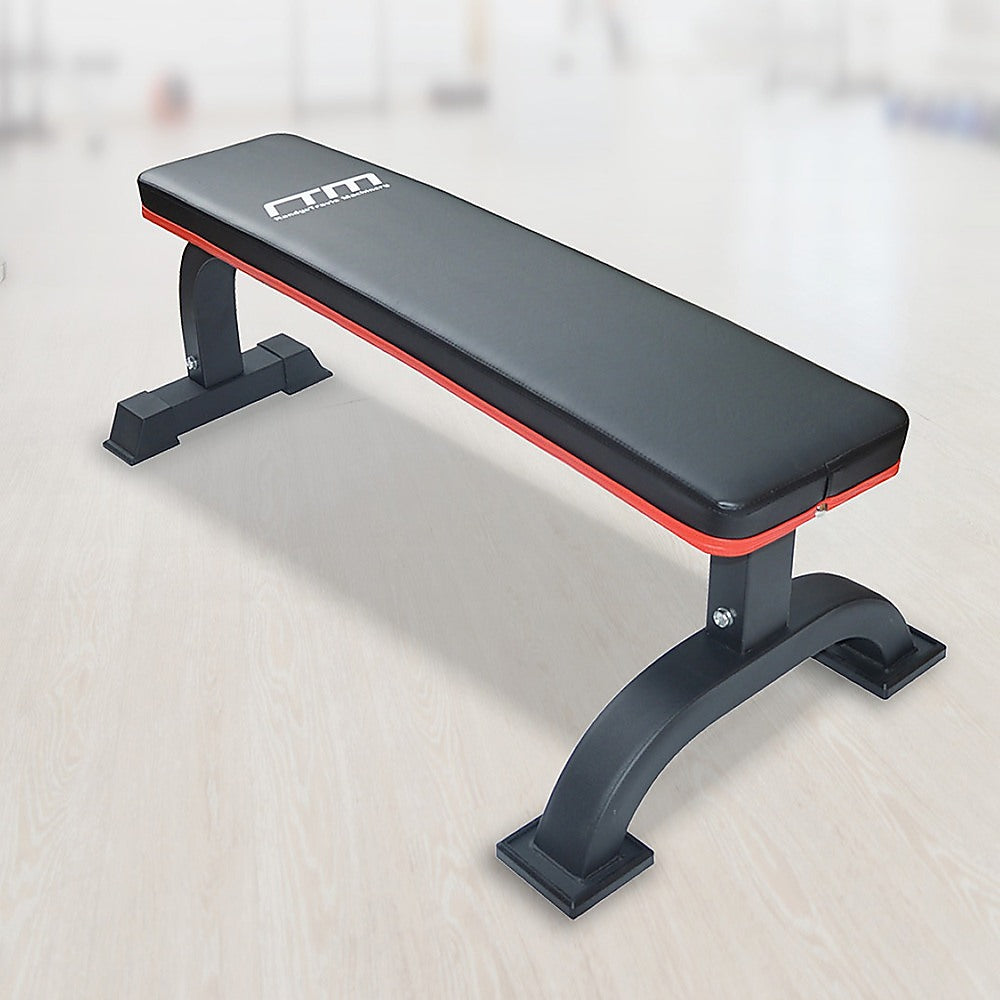 Commercial flat weight lifting bench by Online Fitness Depot with padded surface and sturdy metal frame for gym workouts.