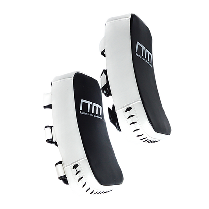 Muay Thai kick boxing pad strike shield used for martial arts training, featuring padded surface and adjustable straps for boxing drills.