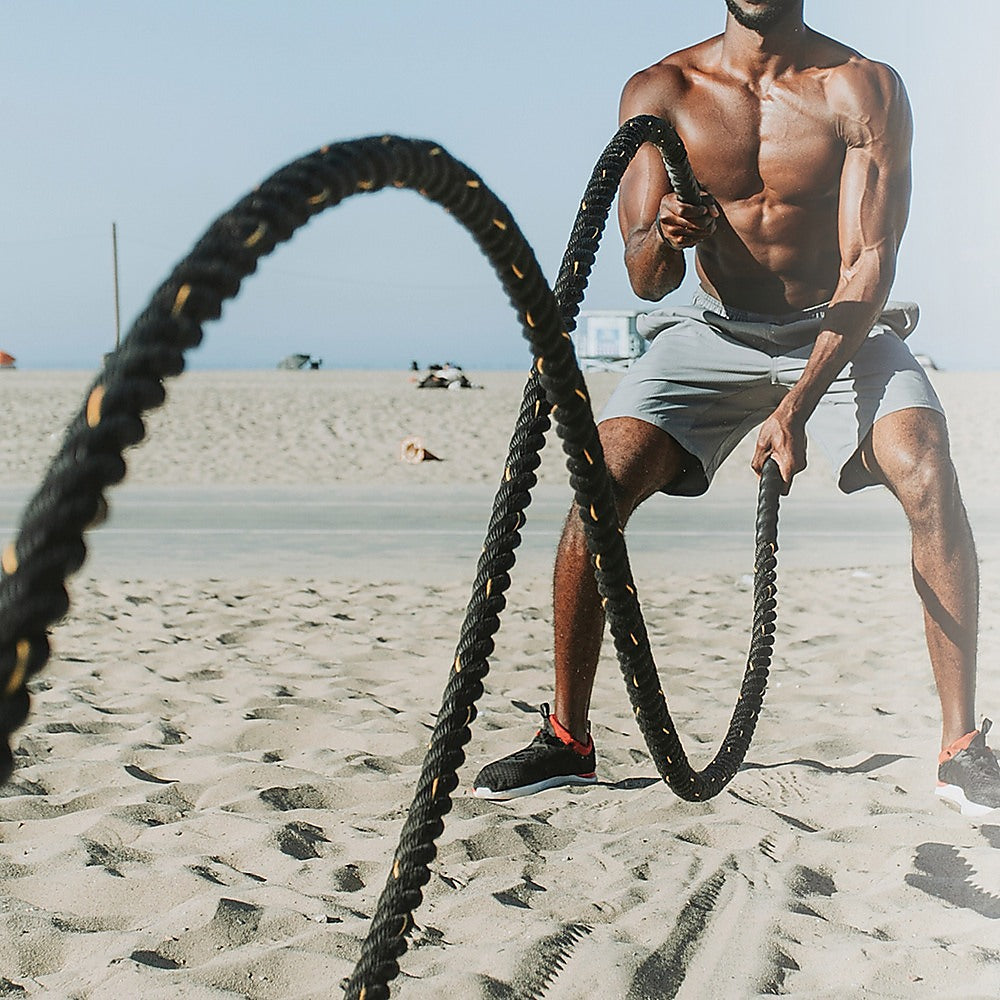 Heavy-duty blue 3.8cm diameter, 9m long battle rope from Online Fitness Depot for strength training and workout exercises.